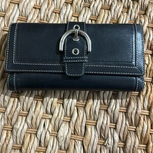 Black coach wallet. Lots of room for cards and checkbook.